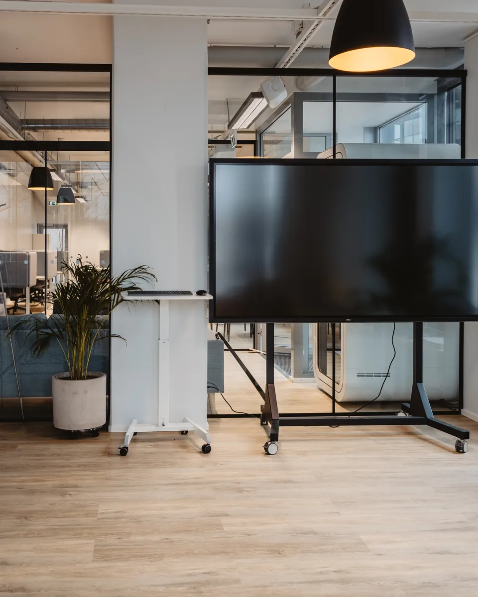 Open coworking space with a presentation screen